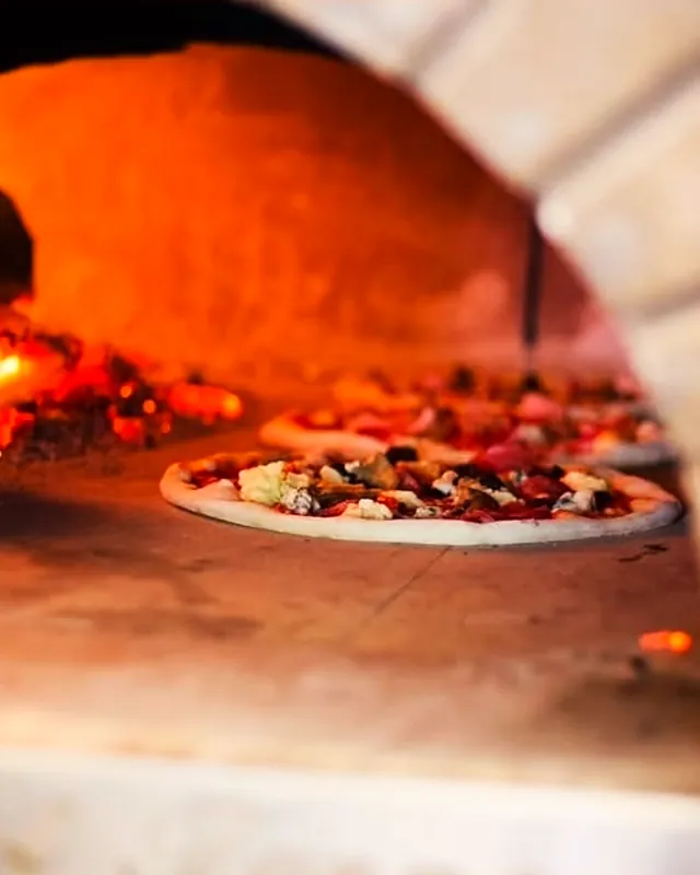 A pizza in the wood-fired oven