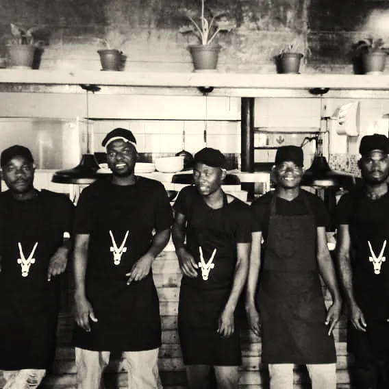 The kitchen crew in their aprons