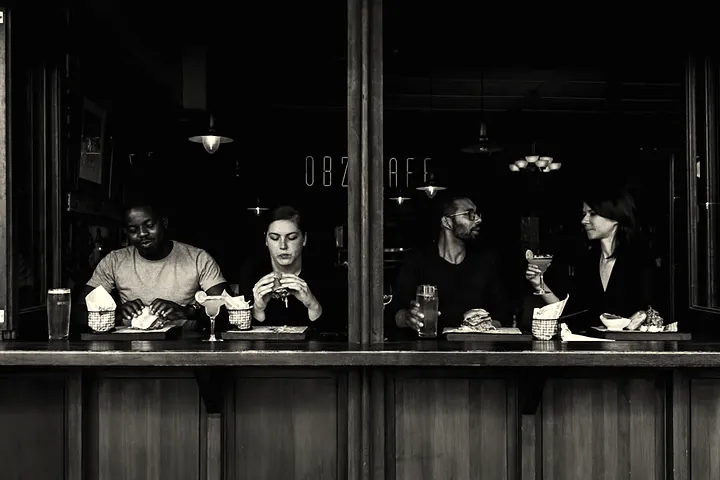 Diners at the window bar at night